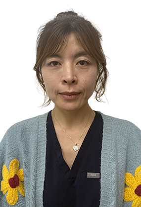 Luna Han, RN injector at AS3 Medical Spa, wearing a light blue cardigan with flower designs and navy scrubs.