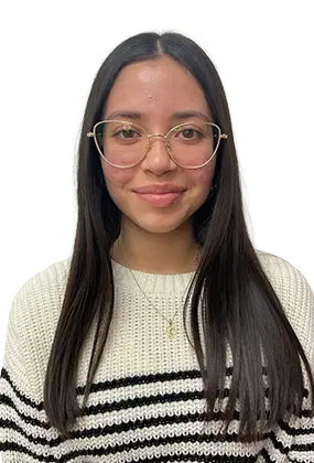 Daniela Flores, front office staff at AS3 Medical Spa, wearing glasses and a striped sweater.