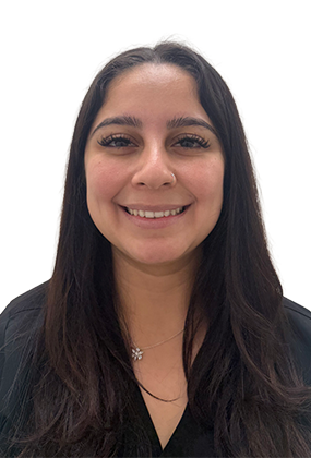 Leslie Gonzalez, front desk receptionist at AS3 Medical Spa, smiling in black medical scrubs.