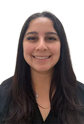 Leslie Gonzalez, front desk receptionist at AS3 Medical Spa, smiling in black medical scrubs.