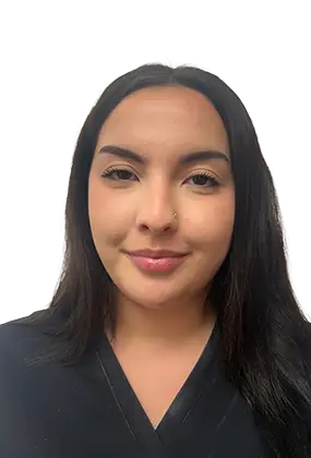 Kaylie Cabrera, front desk receptionist at AS3 Medical Spa, smiling while wearing black medical scrubs.