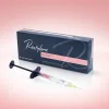 Restylane Kysse, a dermal filler product for lips, displayed on a pink background with a whitish glow surrounding the Restylane Kysse packaging and a syringe in front of it. The product box is dark blue and features the word "Restylane" on the left side, and a pink box on the lower right with the word "Kysse" in it. The image showcases the product packaging and syringe, emphasizing its use for lip enhancement. The overall design conveys a sense of elegance, quality, and femininity, in line with Galderma's brand image | AS3 Med Spa